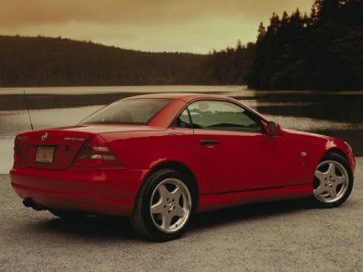 Red hardtop convertible with alloy wheels and sleek design.