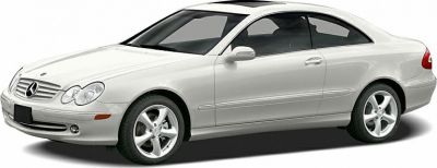 Side profile of a 2002 luxury coupe with alloy wheels and distinct headlights
