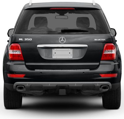 Rear view of SUV with dual exhausts, distinct tail lights, and rear window wiper.