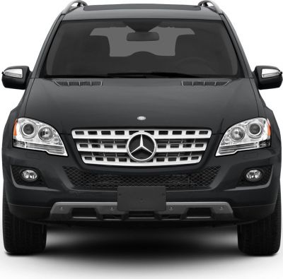 Front view of SUV with chrome grille, headlights, and roof rails