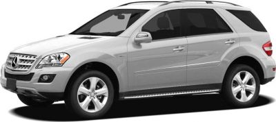 Silver luxury SUV side view with running boards and signature grille