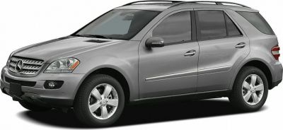 Front side view of a silver mid-size SUV with alloy wheels and roof rails