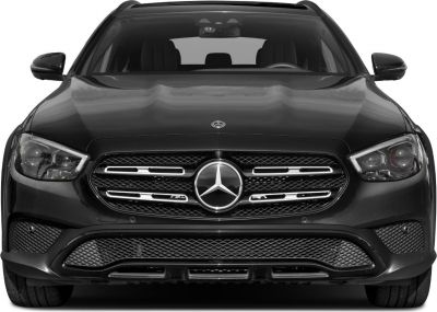 Front view of car grille with emblem and headlights