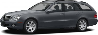 Side profile of a station wagon with distinctive headlights and roof rails