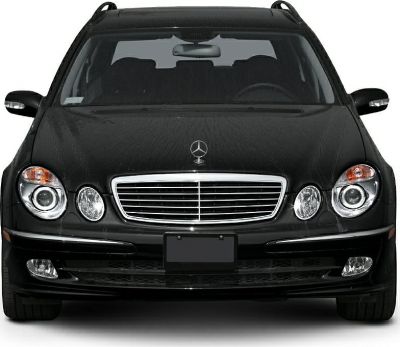 Front view with grille, dual round headlights, and sleek black hood