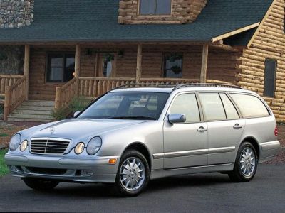 Silver station wagon with dual round headlights and elongated body