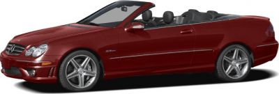 Red luxury convertible with AMG wheels and sleek, classic silhouette.