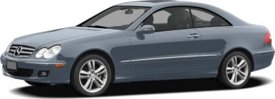 Front side view of a grey luxury coupe with classic grille and alloy wheels