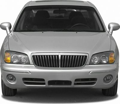 Front view showing classic grille and dual round headlights on silver sedan