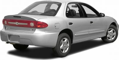 Silver 1990s four-door sedan rear and side view with five-spoke wheels