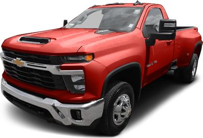 Heavy-duty pickup with crew cab, dual rear wheels, large grille, and hood air vent