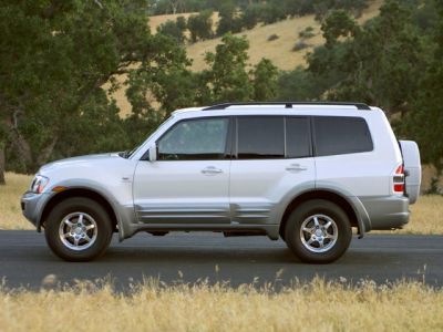Side profile of a classic, rugged SUV with silver body and off-road wheels.