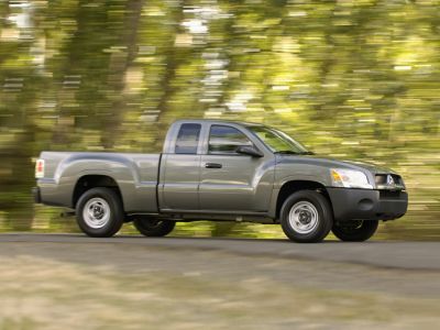 Silver extended cab pickup truck side profile with motion blur