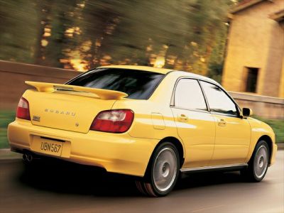 Yellow sedan with rear spoiler and alloy wheels
