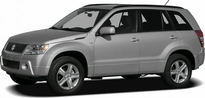 Front side profile of silver mid-2000s SUV with alloy wheels and V6 badge