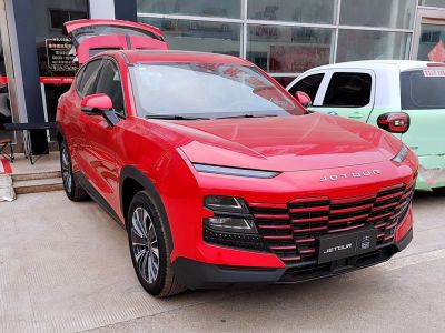 Close-up on front grille and sleek headlights of red SUV
