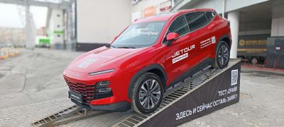 Red SUV with LED headlights and multi-spoke wheels on ramp