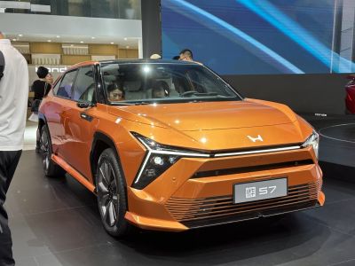 Angular headlights with sharp LED design on an orange electric hatchback