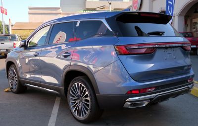 Rear and side exterior view with tail lights and alloy wheels