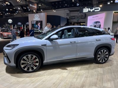 Sleek aerodynamic electric SUV profile with panoramic glass roof and large alloy wheels