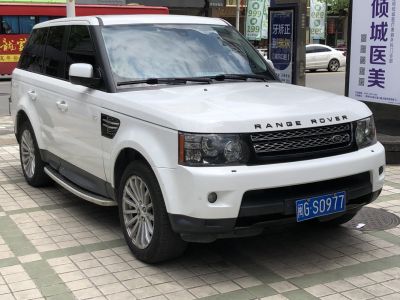 Front and side view of white SUV with grille and alloy wheels