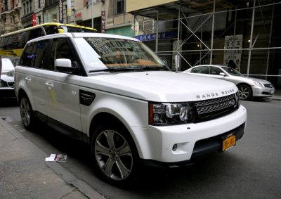 Front-side view of SUV with distinctive grille and headlights
