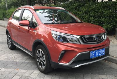 Orange compact SUV front-side with distinctive headlights