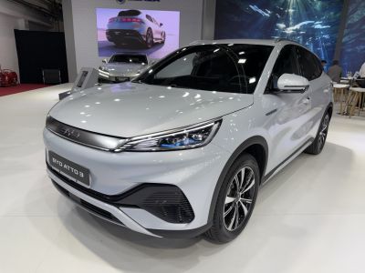 Front-side view of white electric SUV with sleek headlights and aerodynamic design