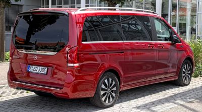 Red electric van rear side with tinted panoramic windows and alloy wheels