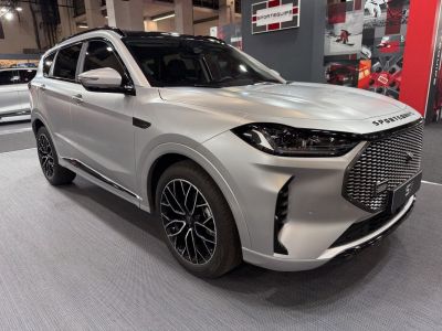 Front view of SUV with bold grille, LED headlights, and alloy wheels