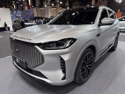 SUV front grille and LED headlights with alloy wheels.