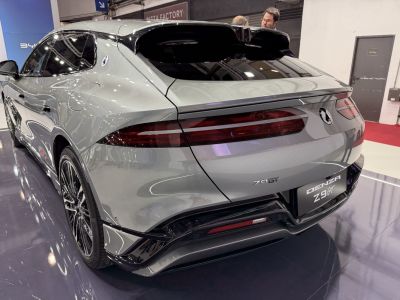 Rear view of modern electric SUV with sleek continuous tail lights and sporty diffuser details