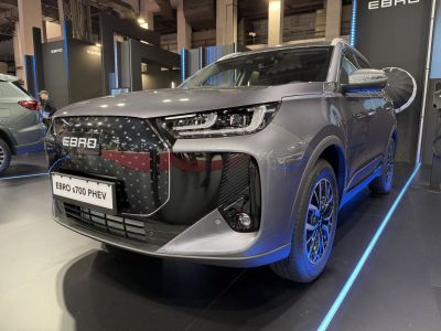 Front grille and LED headlights of modern SUV with alloy wheels