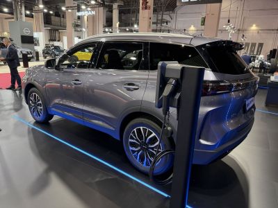 Sleek SUV charging at electric vehicle station indoors