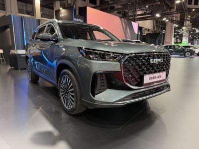 Large diamond-pattern front grille and sleek LED headlights on a modern SUV.