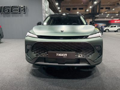Front view featuring large geometric grille and sleek LED headlights.