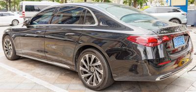 Rear side view of long-body luxury sedan with alloy wheels and taillights
