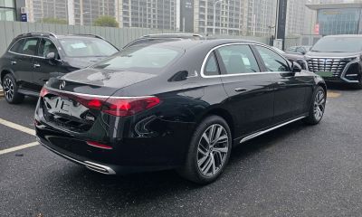 Rear design and distinctive LED taillights of a luxury sedan in rain