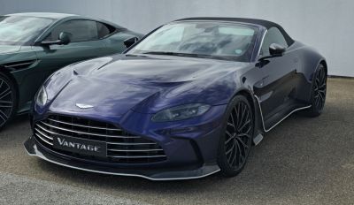 Dark blue convertible sports car with aerodynamic front and soft top