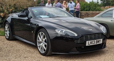 Front grill, headlights, and alloy wheels of black convertible