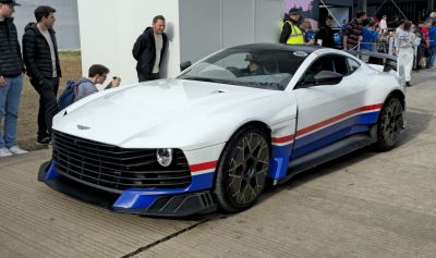 White coupe with racing stripes, aerodynamic body, and sport rims