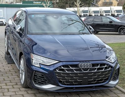 Sporty front grille with sharp LED headlights on a sedan