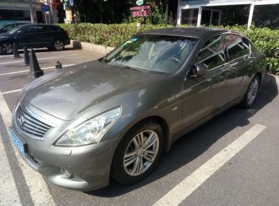 Front side view of a sedan with alloy wheels and modern headlights