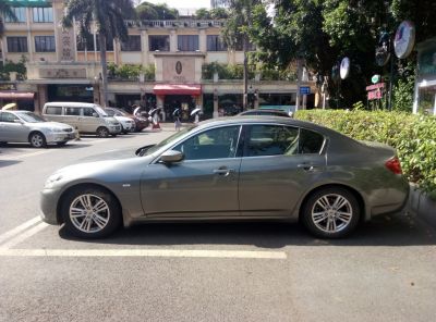 Side profile of a mid-size luxury sedan with alloy wheels and a sleek design.