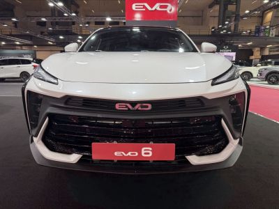 Close-up front view with sleek LED headlights and large grille