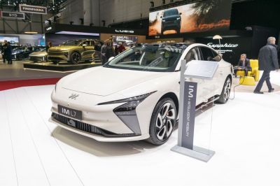 White electric sedan with sharp LED headlights and aerodynamic front design