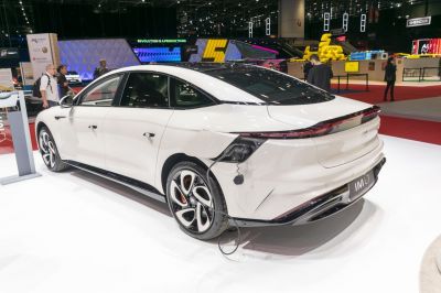 Electric sedan charging with aerodynamic rear and stylish rims