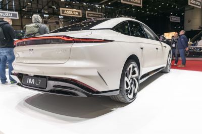 Rear view with continuous taillight bar and aerodynamic bumper.