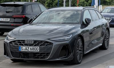 Front view of a modern luxury wagon with sharp LED headlights and a blacked-out grille.