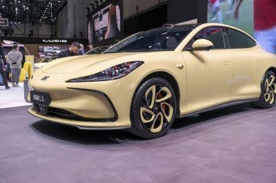 Sleek headlights and distinctive alloy wheels of a modern electric sedan